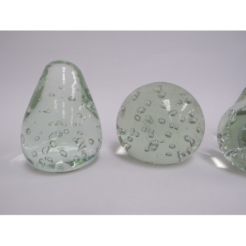 6573 - Four pale green glass dumps with bubble inclusions, tallest 9.5cm