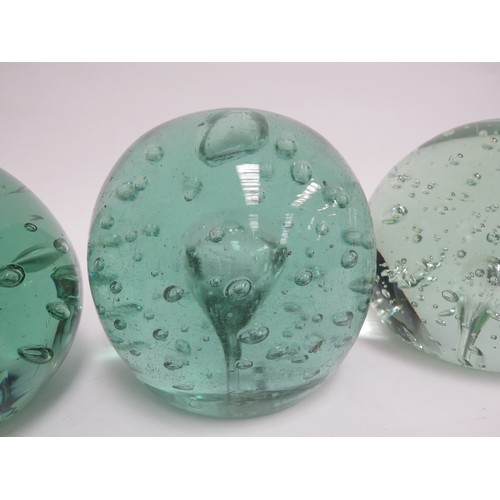 6570 - Three large Victorian green glass dumps with bubble inclusions, 11.5cm tallest