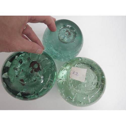 6570 - Three large Victorian green glass dumps with bubble inclusions, 11.5cm tallest