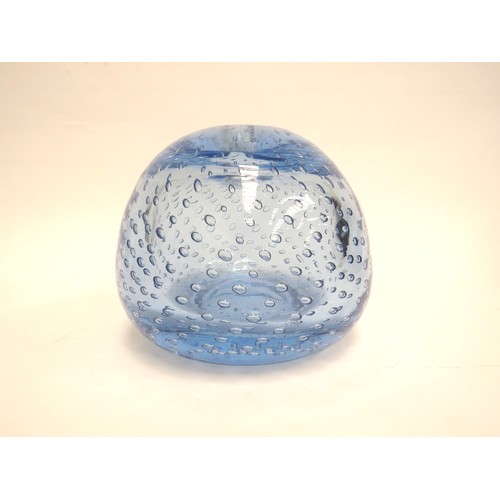 6569 - A large blue dump glass inkwell/candleholder with bubble inclusions, 13cm tall