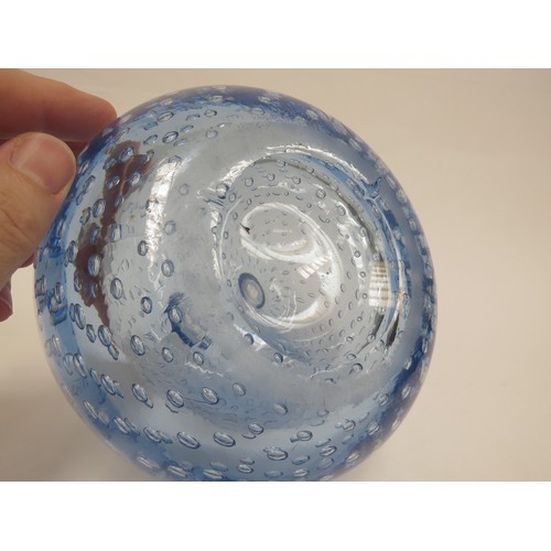 6569 - A large blue dump glass inkwell/candleholder with bubble inclusions, 13cm tall