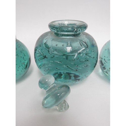 6568 - Three Victorian green dump glass inkwells all with bubble inclusions, (one with stuck stopper and da... 