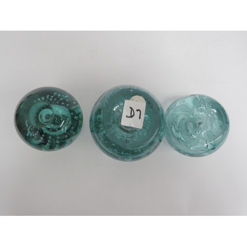 6568 - Three Victorian green dump glass inkwells all with bubble inclusions, (one with stuck stopper and da... 