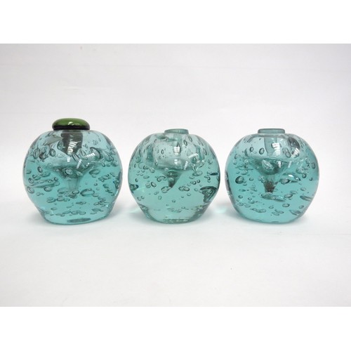 6575 - Three Victorian green dump glass inkwells with bubble inclusions, associated stoppers, tallest appro... 