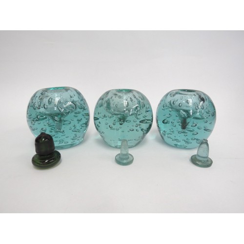 6575 - Three Victorian green dump glass inkwells with bubble inclusions, associated stoppers, tallest appro... 