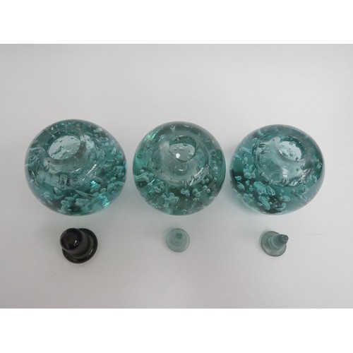 6575 - Three Victorian green dump glass inkwells with bubble inclusions, associated stoppers, tallest appro... 