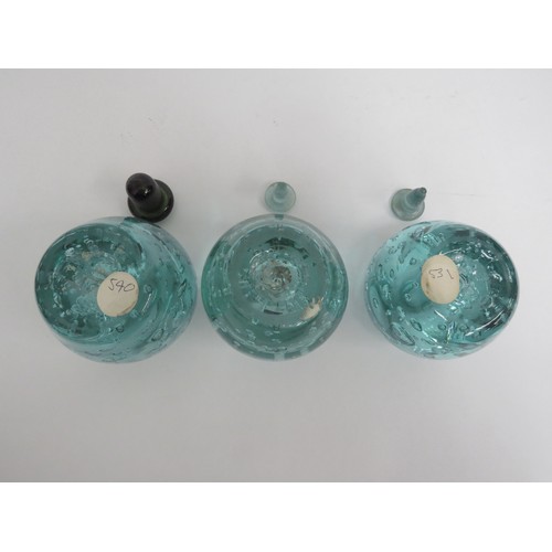 6575 - Three Victorian green dump glass inkwells with bubble inclusions, associated stoppers, tallest appro... 