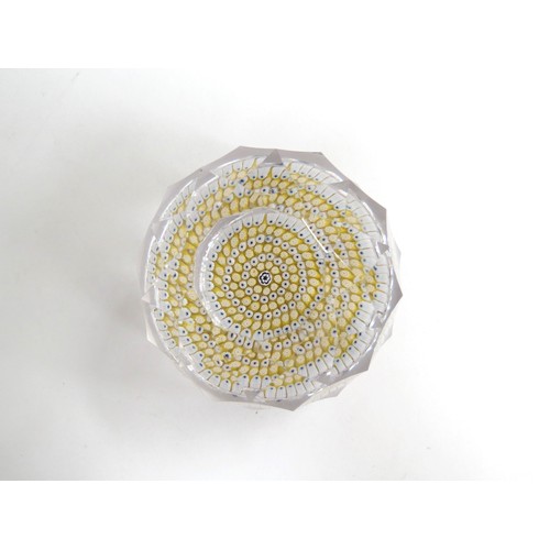 6714 - A Whitefriars facetted glass paperweight with yellow and white millefiori canes