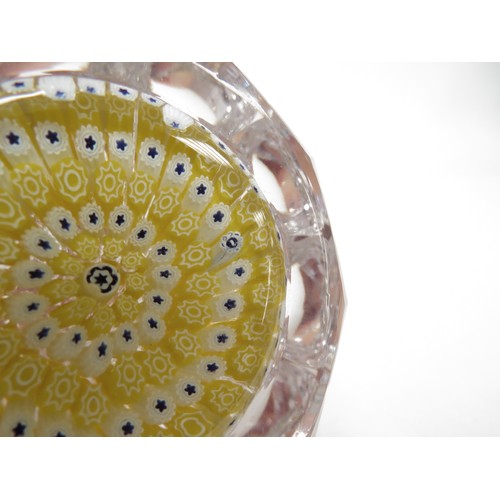 6714 - A Whitefriars facetted glass paperweight with yellow and white millefiori canes