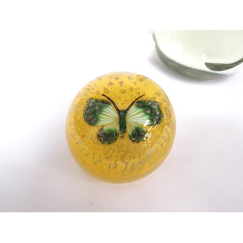 6715 - Three paperweights including yellow with green butterfly, pale yellow glass and another (3)