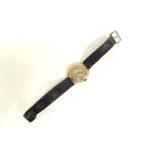 6717 - A 9ct gold wristwatch with Swiss made 15 jewel movement, cased marked N&U, manual wind, worn leather... 