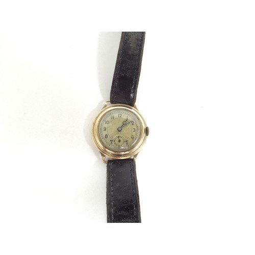 6717 - A 9ct gold wristwatch with Swiss made 15 jewel movement, cased marked N&U, manual wind, worn leather... 