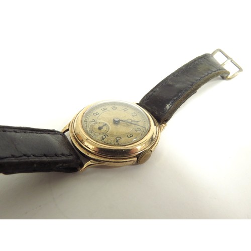 6717 - A 9ct gold wristwatch with Swiss made 15 jewel movement, cased marked N&U, manual wind, worn leather... 