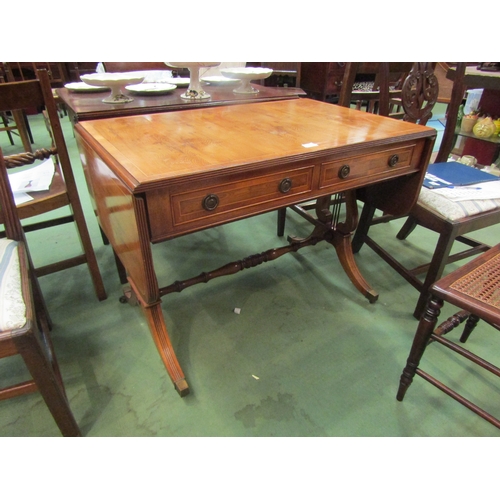 4087 - A yew drop-leaf hall table, lyre form supports, two drawers, on brass castors