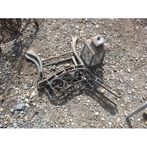 3559 - A pair of cast bench ends and a lantern