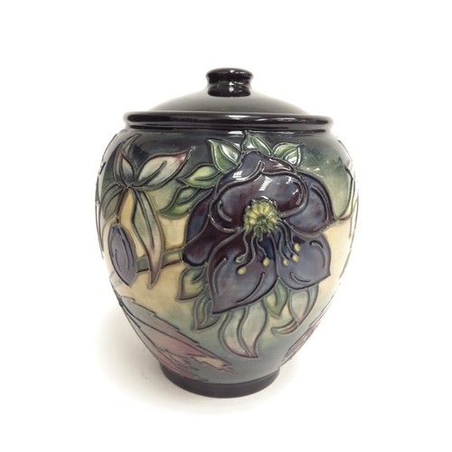 6666 - A Moorcroft Hellebore pattern lidded ginger jar, second, 15cm tall