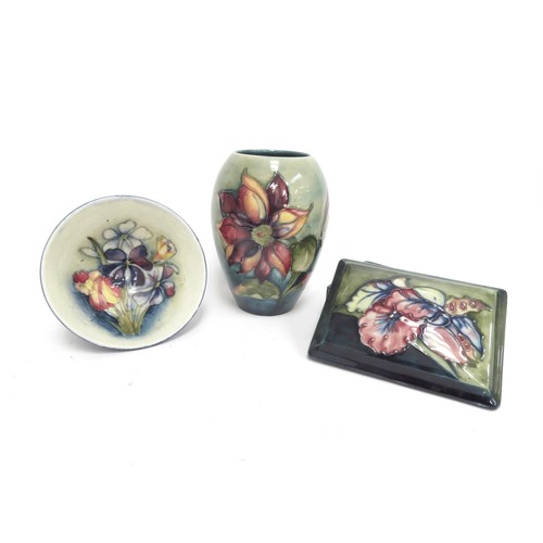 6670 - Three pieces of Moorcroft including Orchid pattern lidded trinket box, Clematis pattern vase 13m tal... 