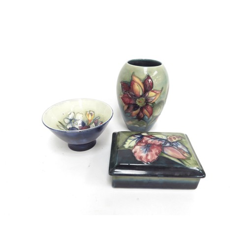 6670 - Three pieces of Moorcroft including Orchid pattern lidded trinket box, Clematis pattern vase 13m tal... 