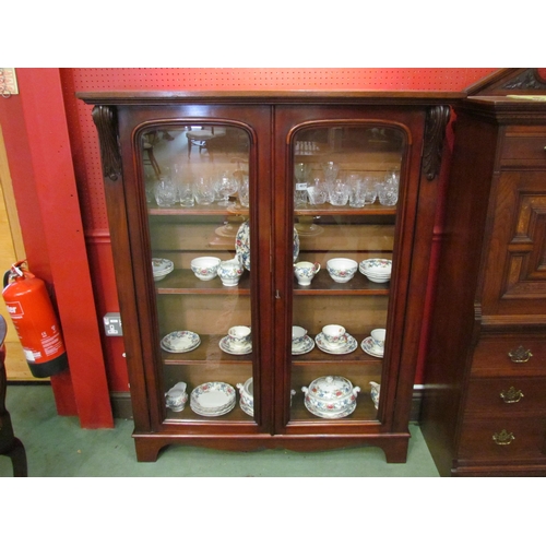 4028 - A Victorian mahogany glazed two door bookcase with height adjustable shelves and acanthus leaf carve... 