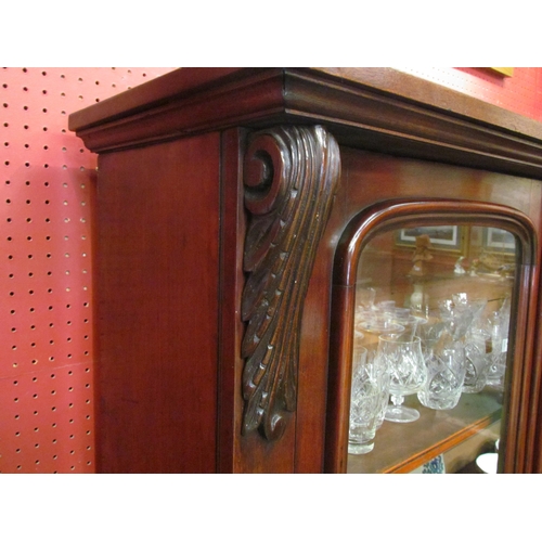 4028 - A Victorian mahogany glazed two door bookcase with height adjustable shelves and acanthus leaf carve... 