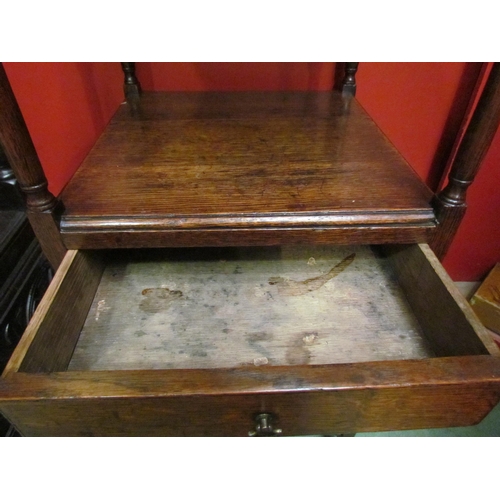 4061 - A George III mahogany gentleman's three tier washstand with central drawer over a flat X-stretcher, ... 