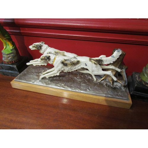 4099 - A painted metal table lighter in the form of two running dogs together with a pair of Deco spelter f... 