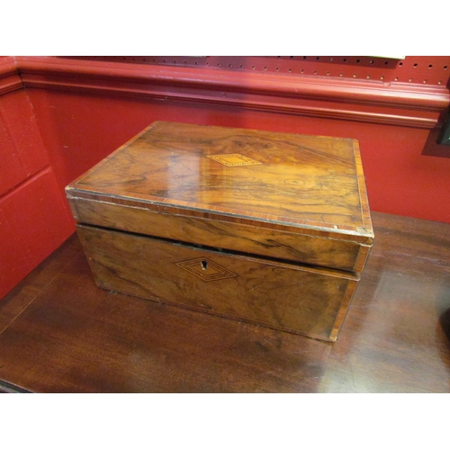 4105 - A Victorian walnut writing box, the lid opening to reveal leather writing surface and fitted interio... 