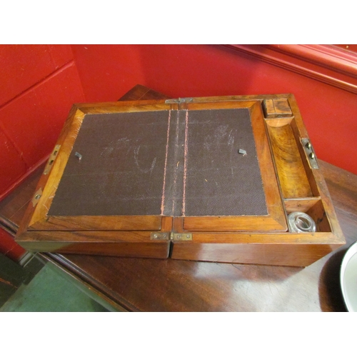 4105 - A Victorian walnut writing box, the lid opening to reveal leather writing surface and fitted interio... 