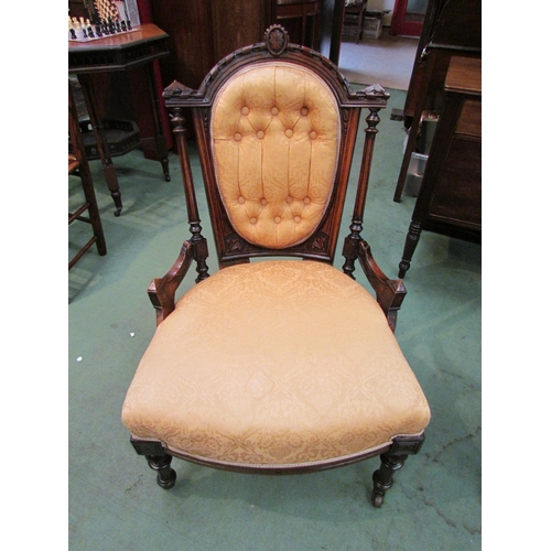 4118 - A late Victorian carved walnut button back armchair over turned and reeded fore legs on ceramic cast... 