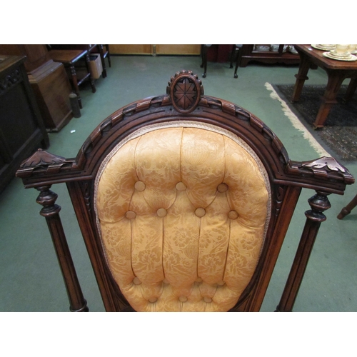 4118 - A late Victorian carved walnut button back armchair over turned and reeded fore legs on ceramic cast... 