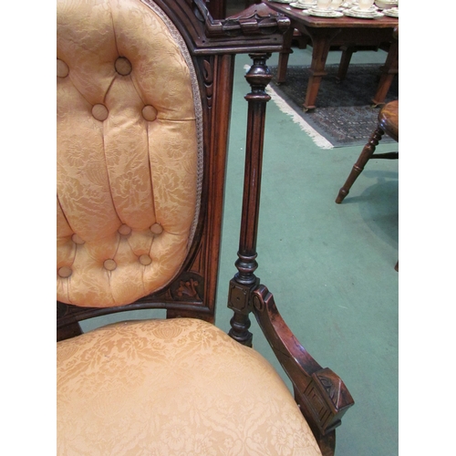 4118 - A late Victorian carved walnut button back armchair over turned and reeded fore legs on ceramic cast... 