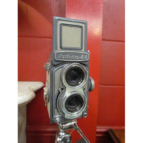 4169 - A cased Yashica-44 twin lens reflex camera on tripod stand and with lens caps