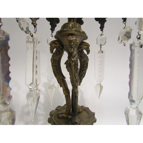 4174 - A pair of gilt metal candlesticks, each with foliate arms holding crystal droplets, 28.5cm tall