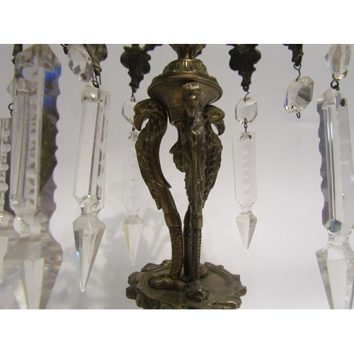 4174 - A pair of gilt metal candlesticks, each with foliate arms holding crystal droplets, 28.5cm tall