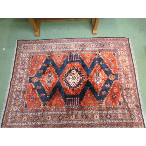 4540 - A Persian wool carpet, red ground, central gul, multiple borders, 230cm x 170cm