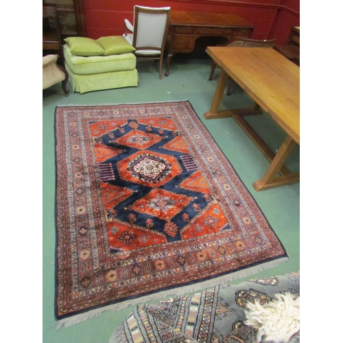 4540 - A Persian wool carpet, red ground, central gul, multiple borders, 230cm x 170cm