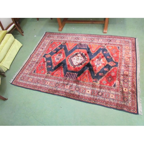 4540 - A Persian wool carpet, red ground, central gul, multiple borders, 230cm x 170cm