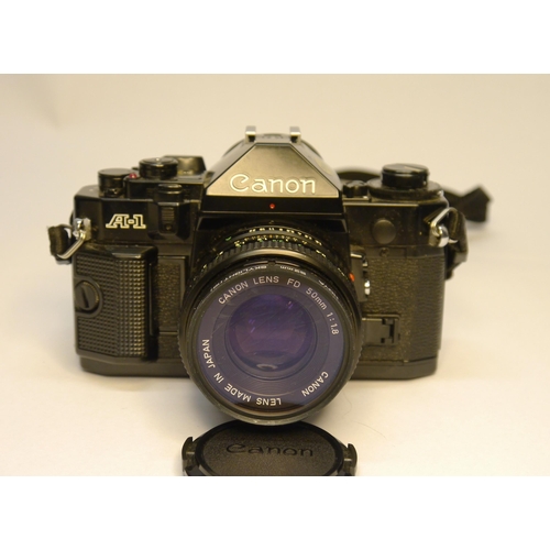 7041 - A Cased Canon AE-1 35mm film SLR body with a Canon FD 35-105mm f3.5 Zoom Manual Focus Lens and Canon... 