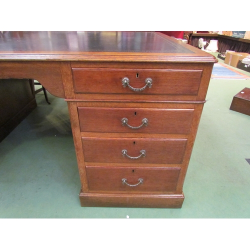 4121 - A large medium oak twin pedestal 'Partners' desk of eight drawers and opposing two single door cupbo... 