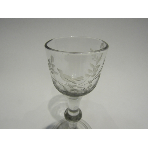 4368 - An 18th Century balustroid wine glass, the bowl etched with foliage and bird, centre knop and folded... 