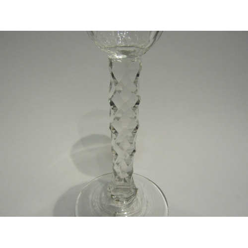 4391 - An 18th Century cordial glass with facet stem and bowl. 13.5cm high