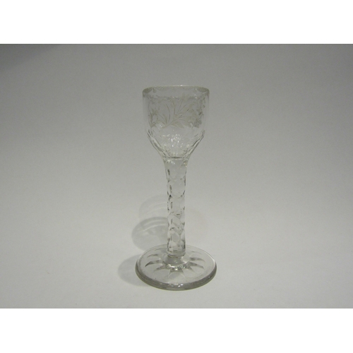 4407 - An 18th Century wine/cordial glass with facet stem, etched floral bowl with swag border.  13.7cm hig... 