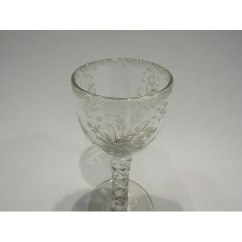 4407 - An 18th Century wine/cordial glass with facet stem, etched floral bowl with swag border.  13.7cm hig... 