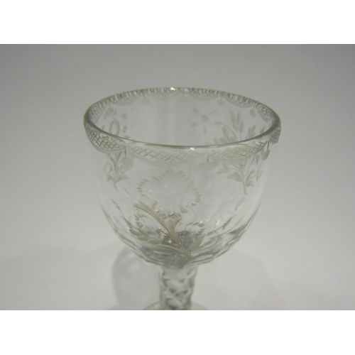 4407 - An 18th Century wine/cordial glass with facet stem, etched floral bowl with swag border.  13.7cm hig... 