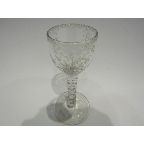 4407 - An 18th Century wine/cordial glass with facet stem, etched floral bowl with swag border.  13.7cm hig... 