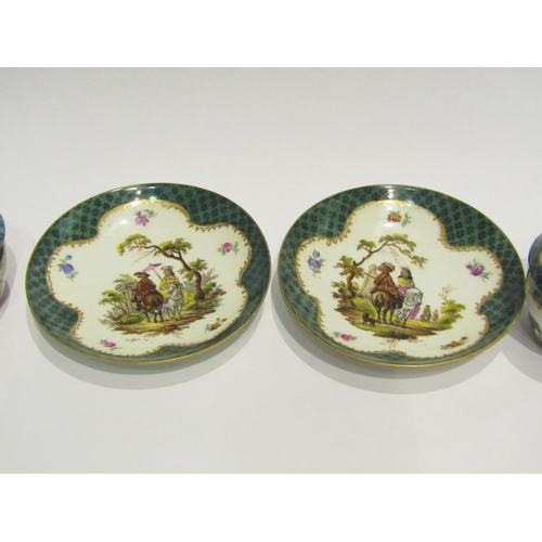 4413 - A pair of Meissen chocolate cups, hand-painted cartouche depicting figures on horse, gilt embellishm... 