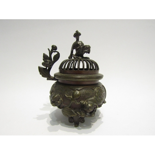 4416 - An Oriental bronze potpourri bowl with finial as a temple dog, apple blossom and temple dog detail, ... 