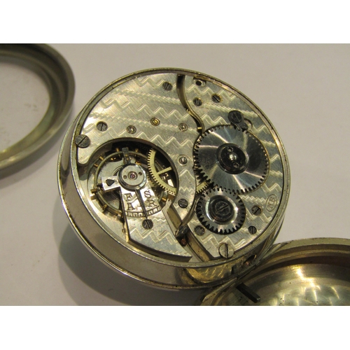 4421 - A nickel plated pocket watch with white enamel dial, set with Roman numerals and subsidiary seconds.... 