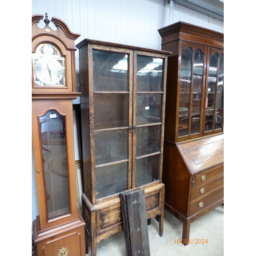 2227 - A 1930's oak and glazed cabinet on stand, one pane missing