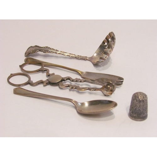 4449 - A silver tea strainer, pair of sugar nips, teaspoon, fork and a thimble (5)